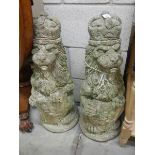 A pair of stone regal lions garden ornaments