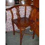 A mahogany corner chair.