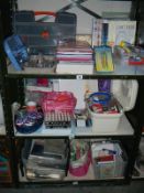 3 shelves of craft work items including ribbons and paper