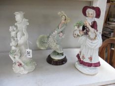 A cherub candlestick and 2 figurines