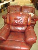 A red 2 seater reclining settee and matching reclining chair