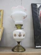 A large oil lamp with shade and chimney