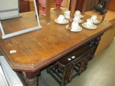 A 1920's extending mahogany dining table