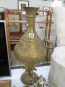 A large Indian brass vase with cobra snake handle