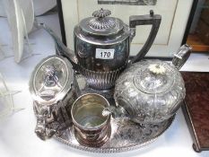 3 silver plated tea pots on a tray