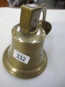 A wall hanging brass bell