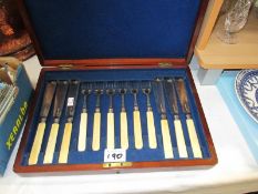 An Edwardian mahogany cased set of silver plated fish knives and forks