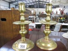 A pair of Victorian brass candlesticks with drip trays