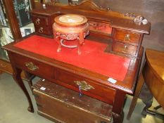 A ladies writing desk with leather insert