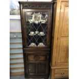 A dark wood corner cupboard