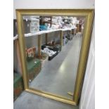 A large gilt framed bevel edged mirror
