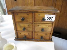 A small old trinket box chest of drawers