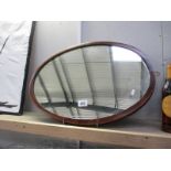 A mahogany framed oval mirror