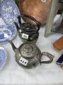 A Victorian black mourning kettle and pewter teapot