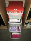 A 4 drawer plastic storage unit containing craft paper etc.