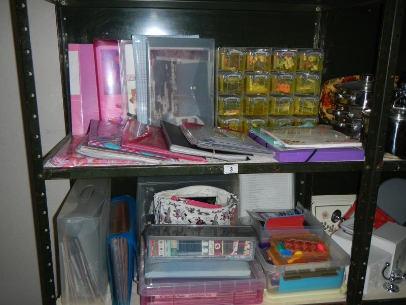 2 shelves containing a good lot of craft work including stamps, paper etc.