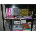 2 shelves containing a good lot of craft work including stamps, paper etc.