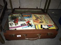 A vintage suitcase full of old annuals