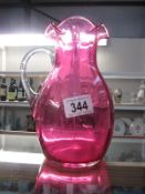 A cranberry glass jug