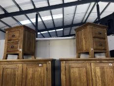 A pair of oak bedside cabinets