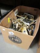 A mixed lot of brass door handles and socket plates etc.