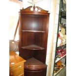 A dark wood stained corner cupboard