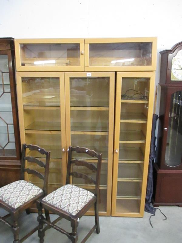 3 light wood display cabinets