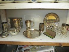 A shelf of silver plate
