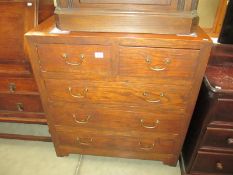 A solid teak chest of drawers with brass handles