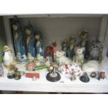 A shelf of animal figures including cats and pigs