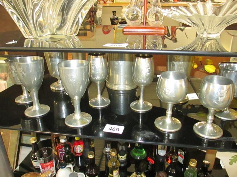 A quantity of pewter goblets and tankard