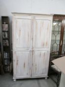 A shabby chic painted pine wardrobe