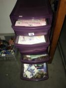 A 4 drawer plastic storage unit containing craft paper etc.