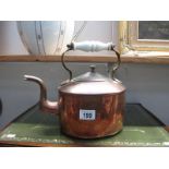 A 19th century copper kettle with ceramic handle