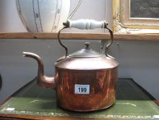 A 19th century copper kettle with ceramic handle