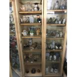 A quantity of wooden owls and teapots over 6 shelves