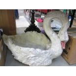 A large stone planter of a swan