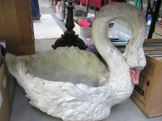 A large stone planter of a swan