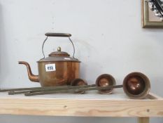 An old copper kettle and 3 copper graduated measures