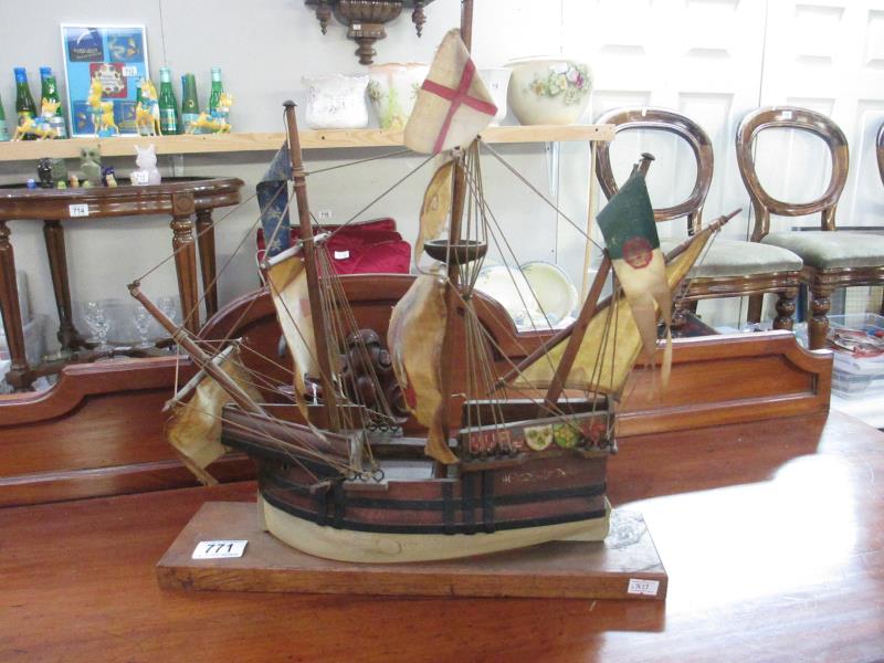 A wooden sailing ship on a plinth