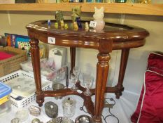 A glass topped occasional table