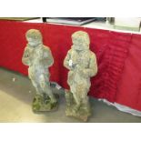 A pair of 'Boy in coat' garden statues,