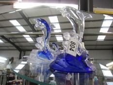 A pair of art glass dolphins