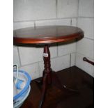 A mahogany tripod table