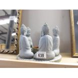 A candle holder in the form of 5 Buddhas in a circle