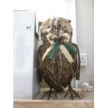 A boxed wicker owl model