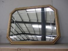 A gilt framed 8 sided mirror