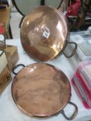 A pair of large Victorian copper pan lids
