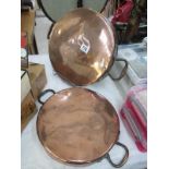 A pair of large Victorian copper pan lids