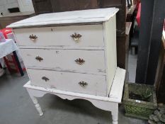 A white painted 3 drawer chest on legs